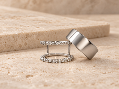HALO Round in 14k white gold beside a silver Oura Ring on travertine