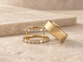 HALO Baguette in 14k yellow gold beside a gold Oura Ring on travertine